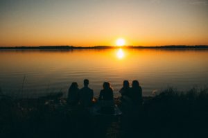 Friends at lake watching sunset